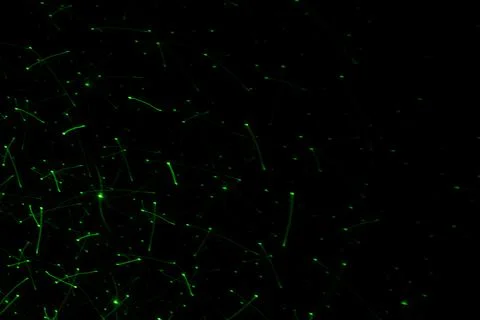 Patterns in green on the wall. Laser background. Party or disco concept. Stock Photos