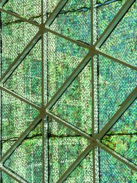 Patterns of light and shadow are visible on a geometric structure in the city Stock Photos