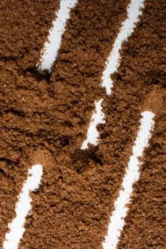 Patterns of lines shaped with splashed coffee on the white surface Stock Photos