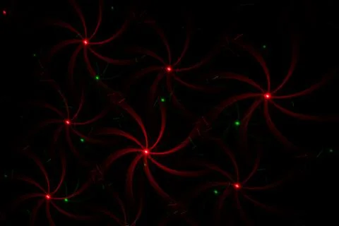 Patterns in red and green on the wall. Laser background. Party or disco conce Stock Photos