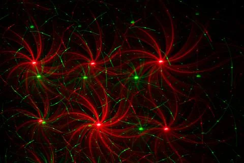 Patterns in red and green on the wall. Laser background. Party or disco conce Stock Photos