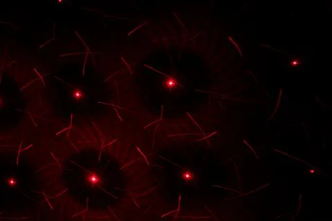 Patterns in red on the wall. Laser background. Party or disco concept. Stock Photos