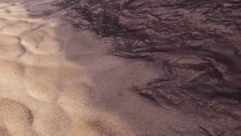 Patterns on sand and dark material at the beach during sunlight Stock Footage 344551351