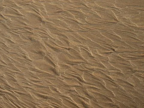 Patterns in the sand created by the low tide Stock Photos