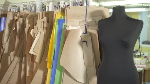 Patterns for sewing on a clothes rack in the studio Stock Footage 124282447