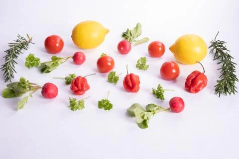 Patterns of tomatoes, lemons and peppers on a table Stock Photos
