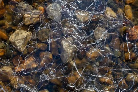 Patterns on transparent layered thin ice Stock Photos