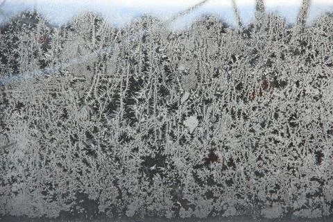 Patterns on the window in winter. Winter drawing on the window. Natural patte Stock Photos