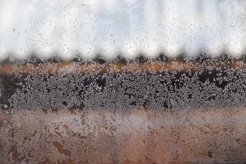 Patterns on the window in winter. Winter drawing on the window. Natural patte Stock Photos