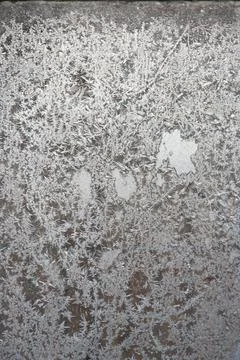 Patterns on the window in winter. Winter drawing on the window. Natural patte Stock Photos