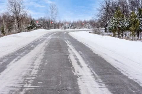 Patterns on the winter highway in the form of four straight lines. Snowy road Stock Photos