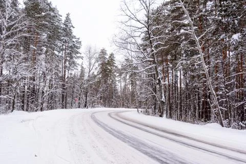 Patterns on the winter highway in the form of four straight lines. Snowy road Stock Photos