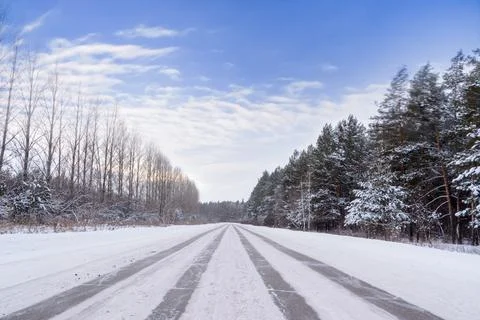 Patterns on the winter highway in the form of four straight lines. Snowy road Stock Photos