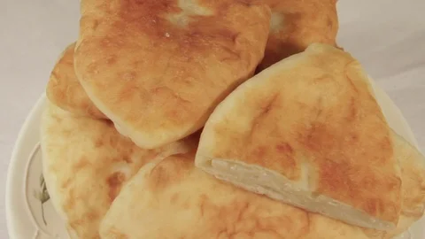 Patties with stuffing of potatoes rotating on light background Stock Footage 70070580