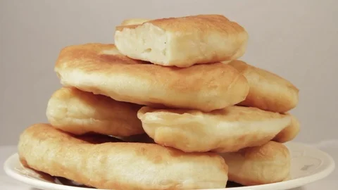 Patties with stuffing of potatoes rotating on light background Stock Footage 70070606