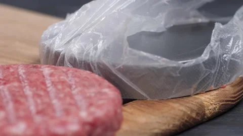 A patty falls from the burger press. The process of making hamburgers. Video stock 222616638