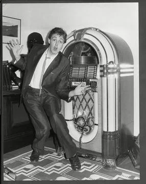 Paul Mccartney Pictured Next To A Jukebox At His Soho Offices In London. 1985 Stock Photos