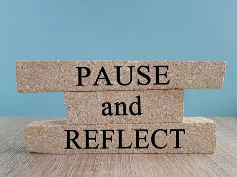 Pause and Reflect symbol. Concept words Pause and Reflect on brick blocks. Stock Photos