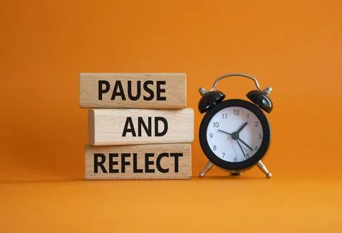 Pause and Reflect symbol. Concept words Pause and Reflect on wooden blocks... Stock Photos