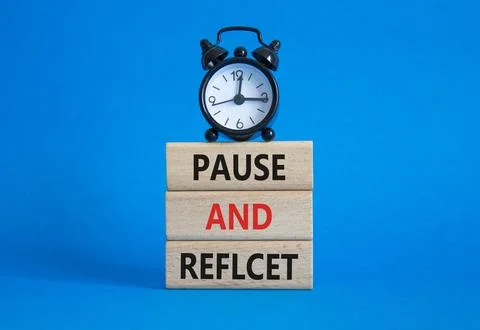 Pause and Reflect symbol. Concept words Pause and Reflect on wooden blocks... Stock Photos