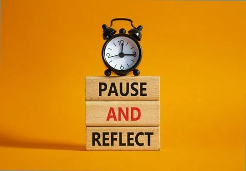 Pause and Reflect symbol. Concept words Pause and Reflect on wooden blocks... Stock Photos