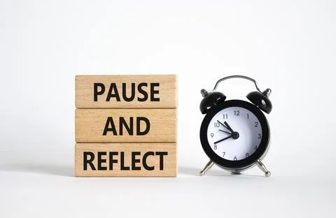 Pause and Reflect symbol. Concept words Pause and Reflect on wooden blocks... Stock Photos