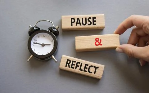 Pause and Reflect symbol. Concept words Pause and Reflect on wooden blocks... Stock Photos