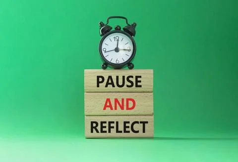 Pause and Reflect symbol. Concept words Pause and Reflect on wooden blocks... Stock Photos