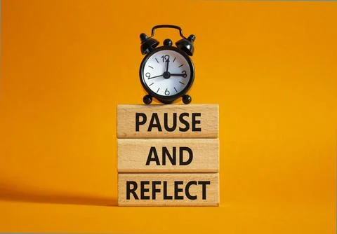Pause and Reflect symbol. Concept words Pause and Reflect on wooden blocks... Stock Photos