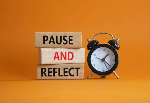 Pause and Reflect symbol. Concept words Pause and Reflect on wooden blocks... Stock Photos