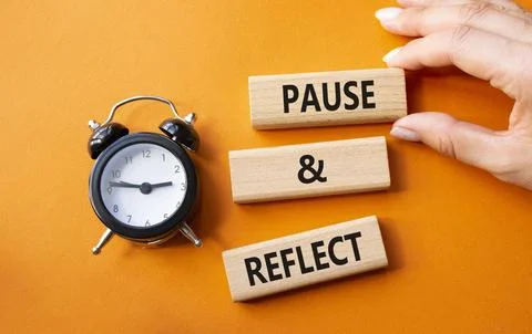 Pause and Reflect symbol. Concept words Pause and Reflect on wooden blocks... Stock Photos