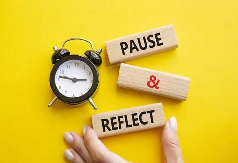 Pause and Reflect symbol. Concept words Pause and Reflect on wooden blocks... Stock Photos