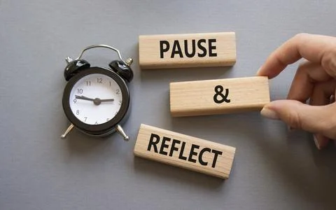 Pause and Reflect symbol. Concept words Pause and Reflect on wooden blocks... Stock Photos