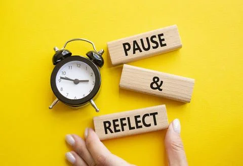 Pause and Reflect symbol. Concept words Pause and Reflect on wooden blocks... Stock Photos