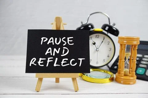 Pause And Reflect text with magnifying glass and calculator on wooden backg.. Stock Photos