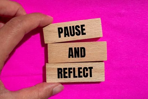 Pause and reflect words written on wooden blocks with pink background. Concep Stock Photos