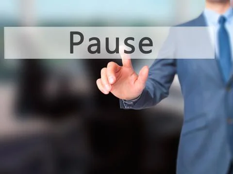 Pause - Businessman hand pressing button on touch screen interface. Stock Photos