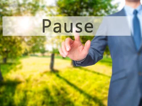 Pause - Businessman hand pressing button on touch screen interface. Stock Photos