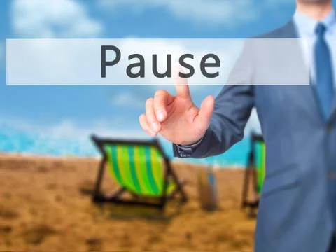 Pause - Businessman hand pressing button on touch screen interface. Stock Photos