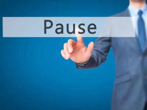 Pause - Businessman hand pressing button on touch screen interface. Stock Photos