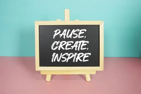 Pause, Create, Inspire text on easel blackboard Stock Photos