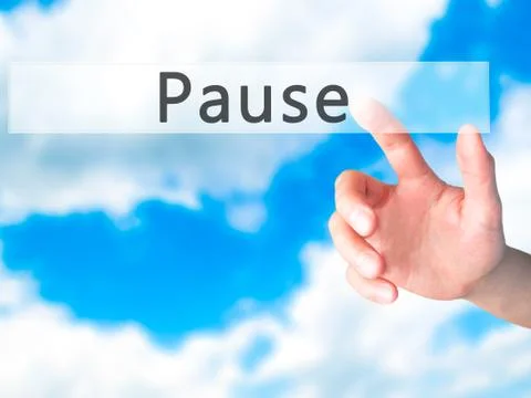 Pause - Hand pressing a button on blurred background concept on visual screen Stock Photos