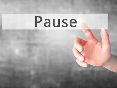 Pause - Hand pressing a button on blurred background concept on visual screen Stock Photos