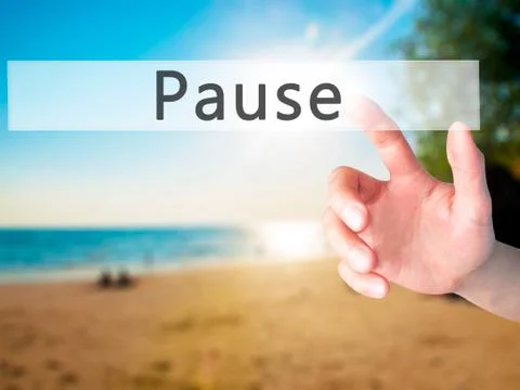 Pause - Hand pressing a button on blurred background concept on visual screen Stock Photos