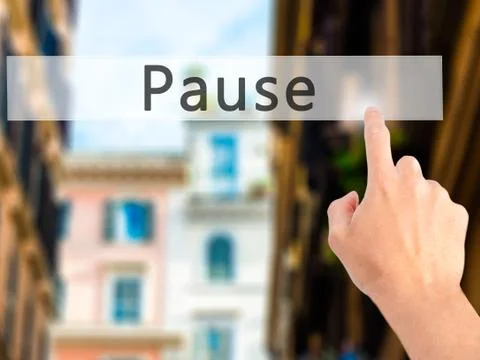 Pause - Hand pressing a button on blurred background concept on visual screen Stock Photos