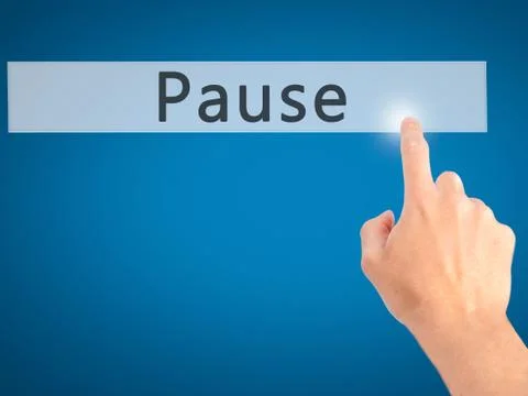 Pause - Hand pressing a button on blurred background concept on visual screen Stock Photos