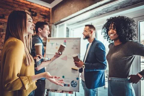 Pause for relax at work. Happy work team during break time in light modern of Stock Photos