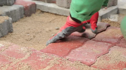Pave the way Hands Are Fitting Flagstone Stock Footage 65518226