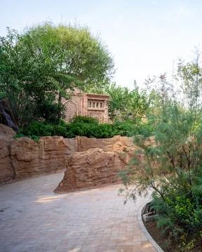 Paved path between artificial rock walls in a park - Adventure concept Stock Photos