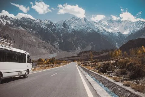 Paved road with a view of snow capped mountain range, Karakoram highway. Stock Photos